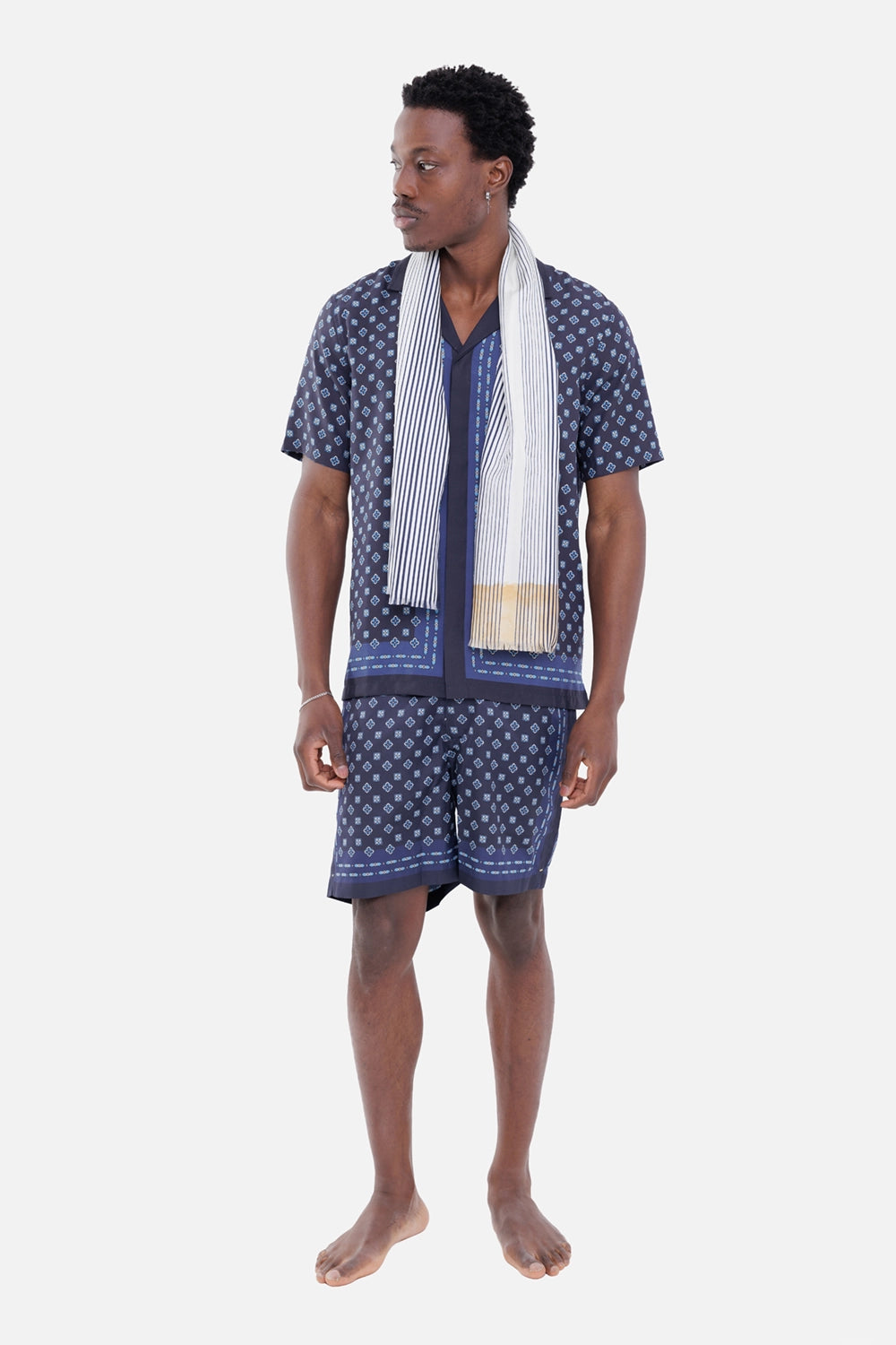 Orlebar Brown men's resort shirt in Night Iris, on-model full-length with matching shorts and geometric border print