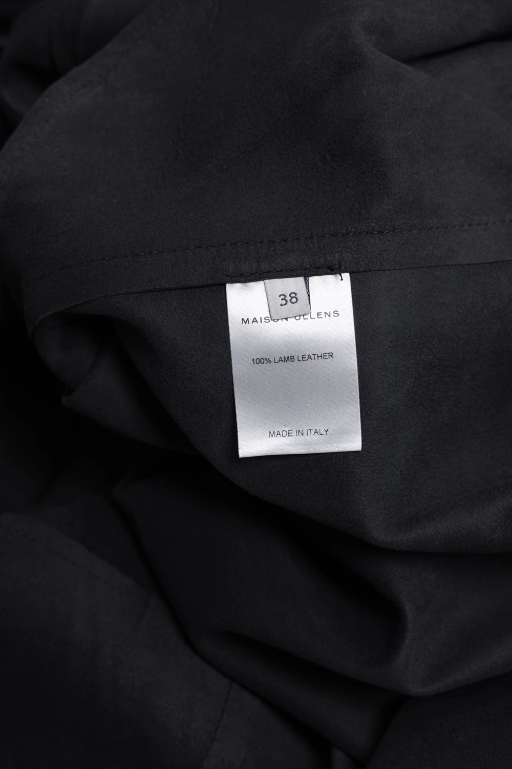 Pre-owned Maison Ullens label close-up on black dress, size 38 tag showing 100% lamb leather and made in Italy