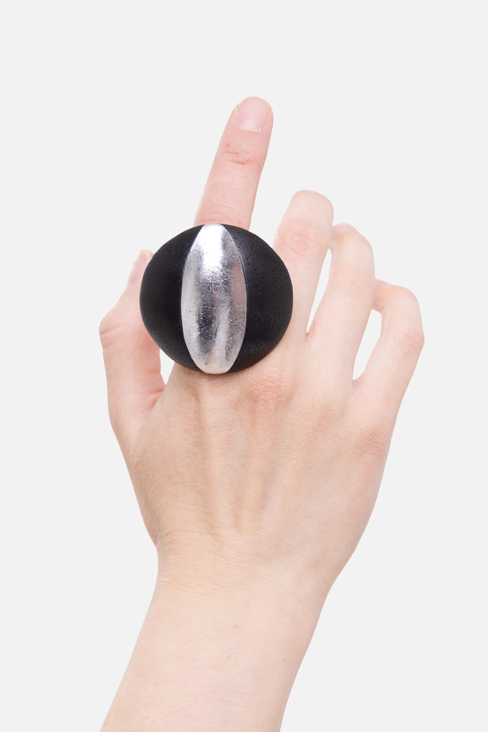 Monies women's ring in black/silver, on-hand view, round wood disc with vertical silver-foil panel