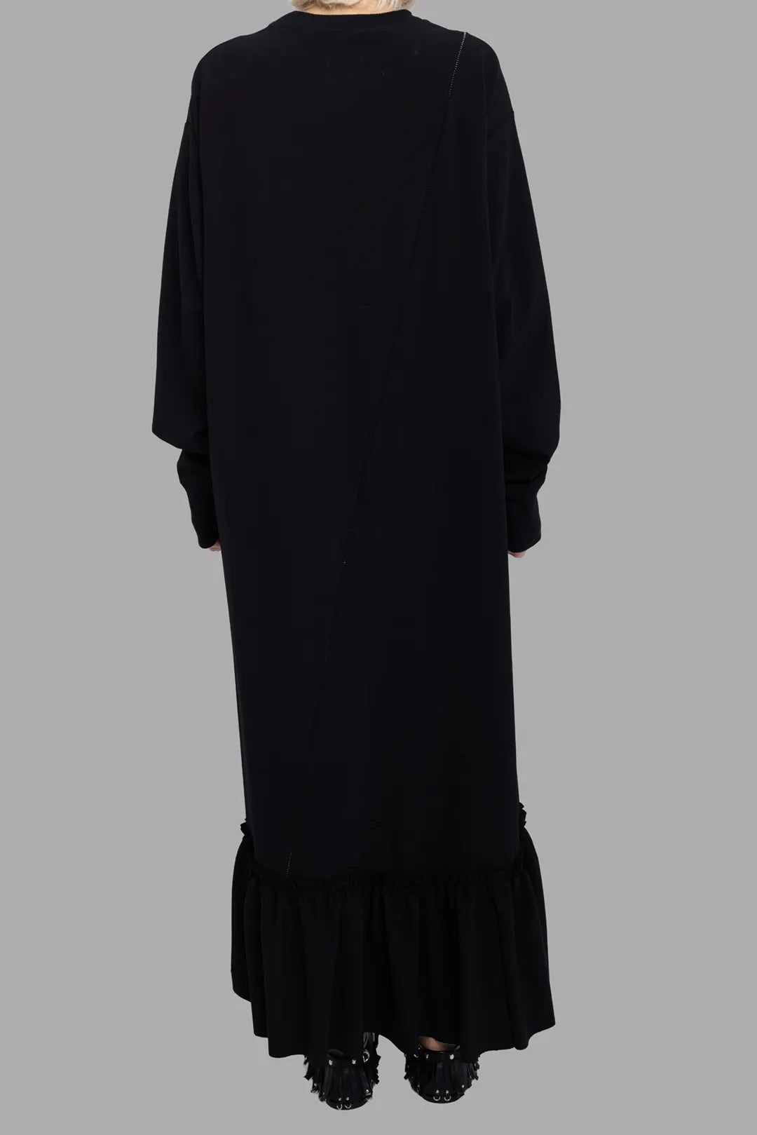Marc Point women's black ruffle-hem jersey dress, back view, longline silhouette with gathered flounce hem.