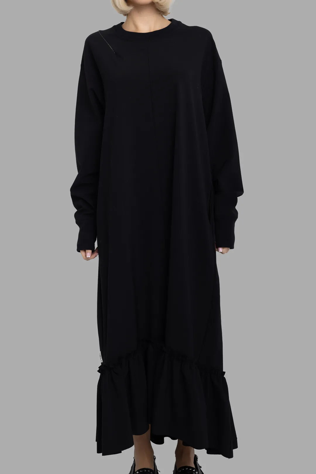 Marc Point women's black ruffle-hem jersey dress, front view, crew neck with diagonal seam and long sleeves.