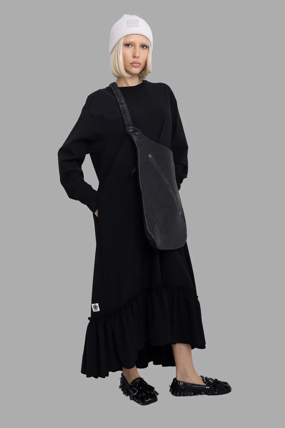 Marc Point women's black ruffle-hem jersey dress, on-model full length, oversized fit with gathered hem.