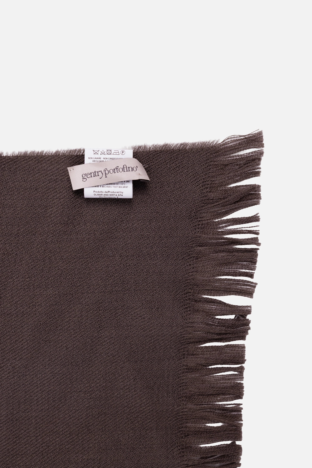 Gentry Portofino unisex scarf in Mastice, label detail with woven branding and long wool fringe