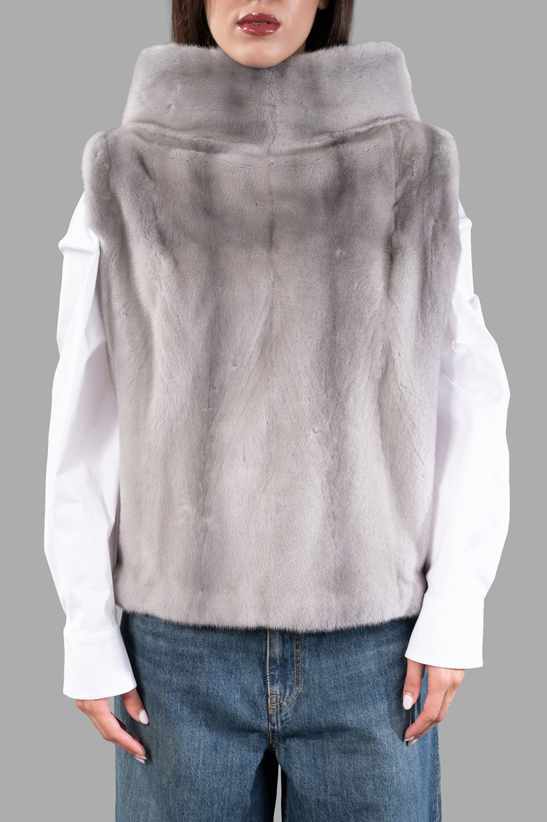 Inès & Maréchal Fur Vest in grey, showcasing luxurious shearling texture and hooded design, perfect for modern layering.