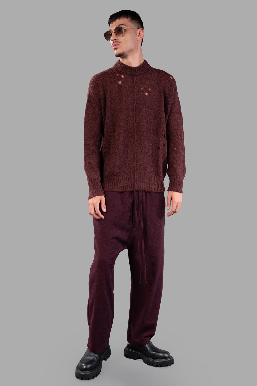 Marc Point Rusty Red Sweater on model, burgundy wool with distressed details, crewneck, ribbed cuffs for a classic look.