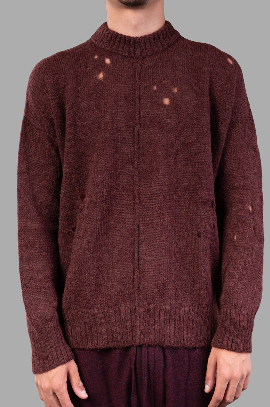 Marc Point Rusty Red Sweater featuring a cozy crewneck and distressed details, displayed on a model from the front.