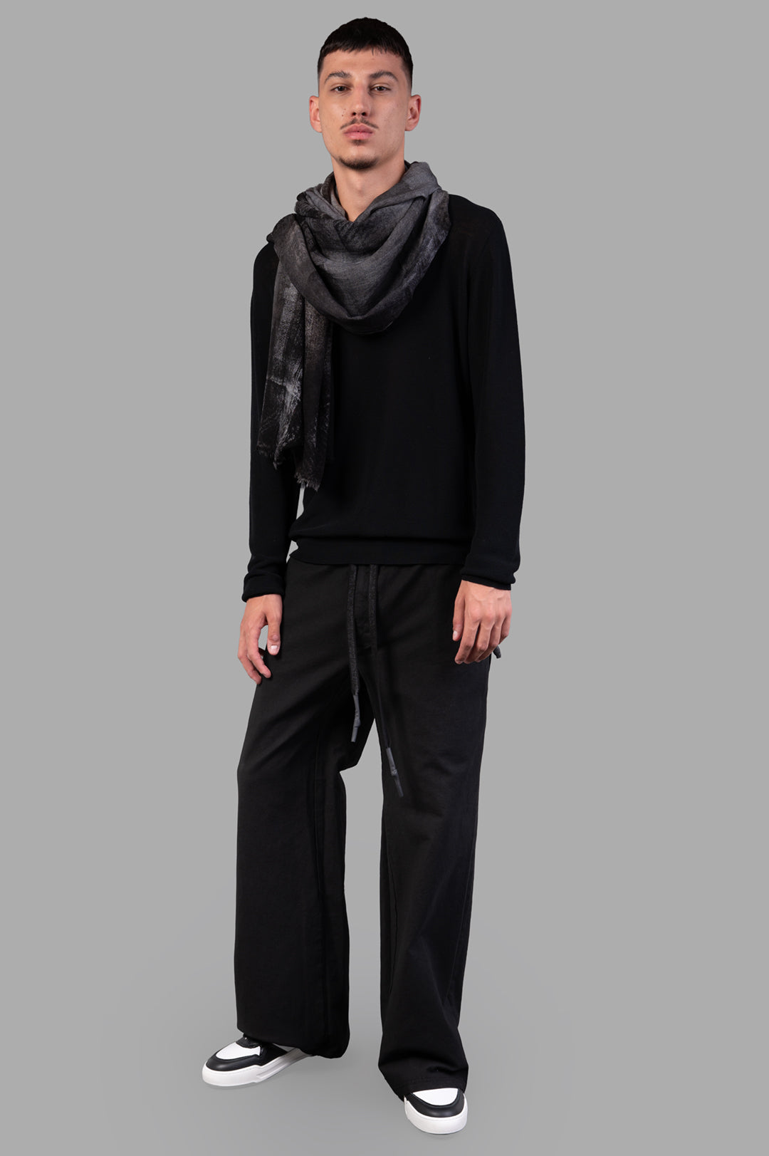 Isaac Sellam Drawstring Trousers in black, front view on-model, showcasing wide-legged silhouette and relaxed fit.