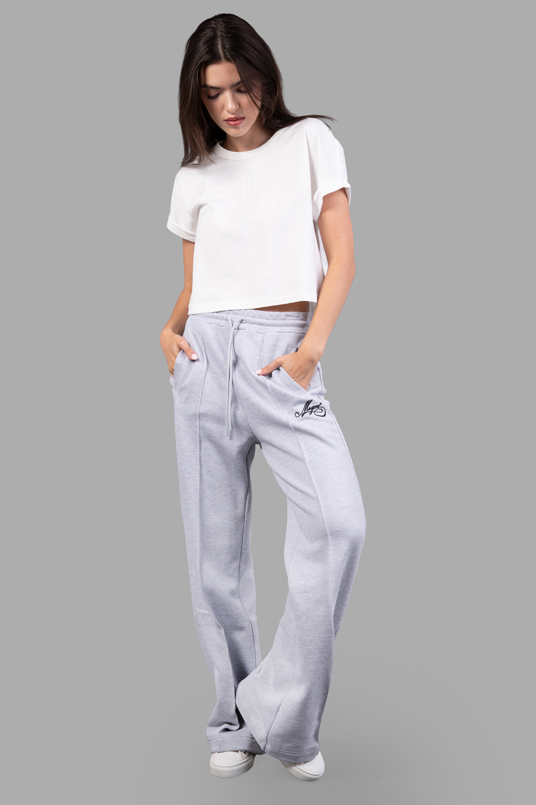 MSGM grey Logo Track Pants on-model front view, featuring embroidered logo, elastic waistband, and drawstring for comfort.