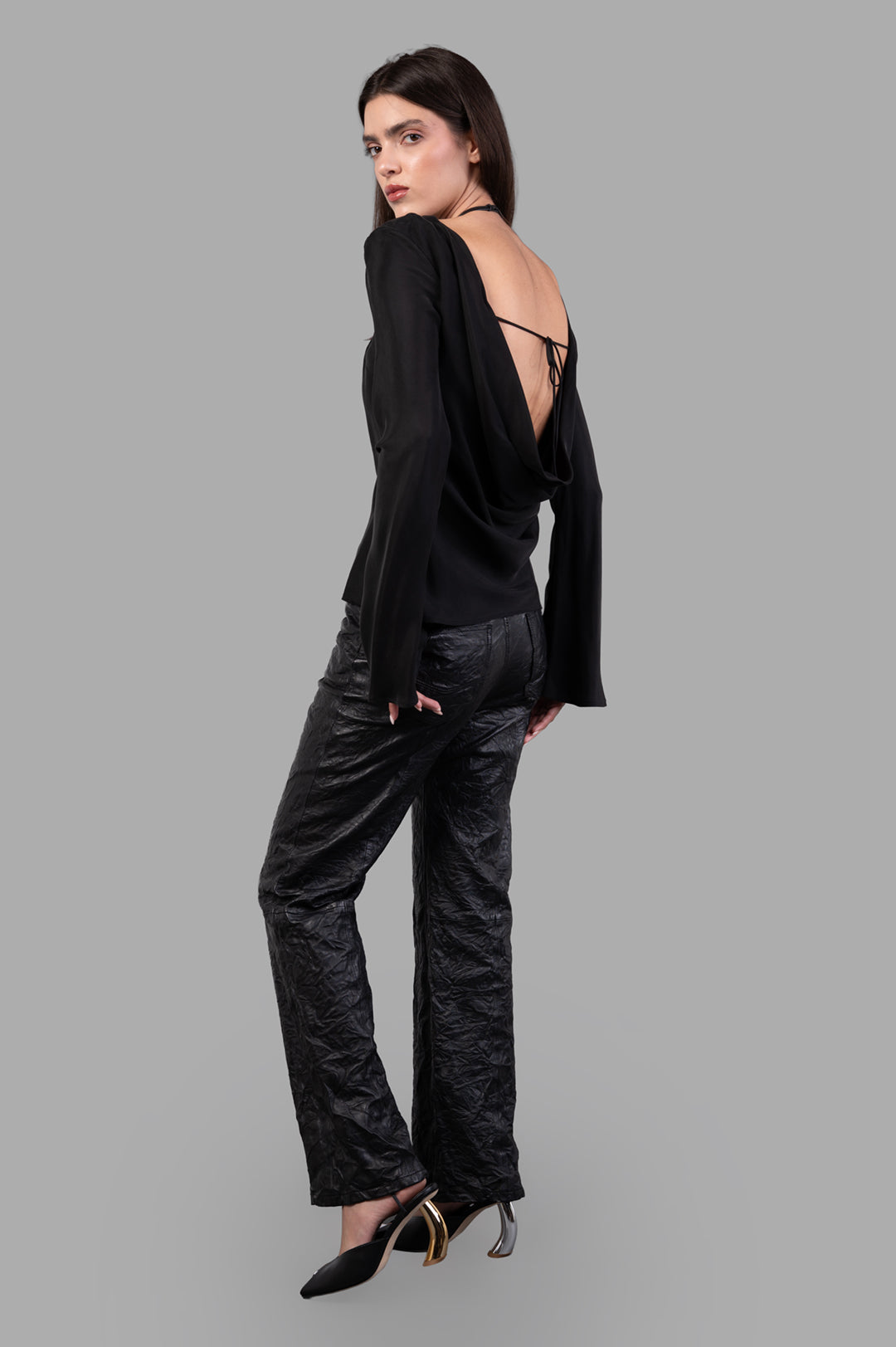 By Malene Birger Laura Blouse in black, back view showing open drape and adjustable ties, on-model for a festive look.