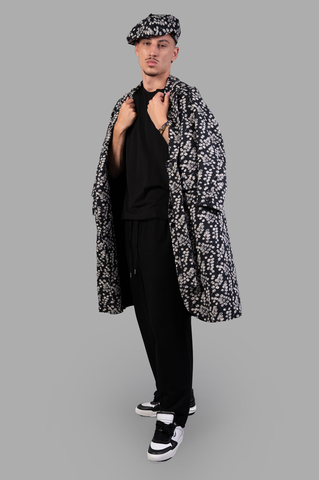 Helmut Lang Minimal Sweatpants in black cotton terry, styled on model with floral coat, showing front view and texture.