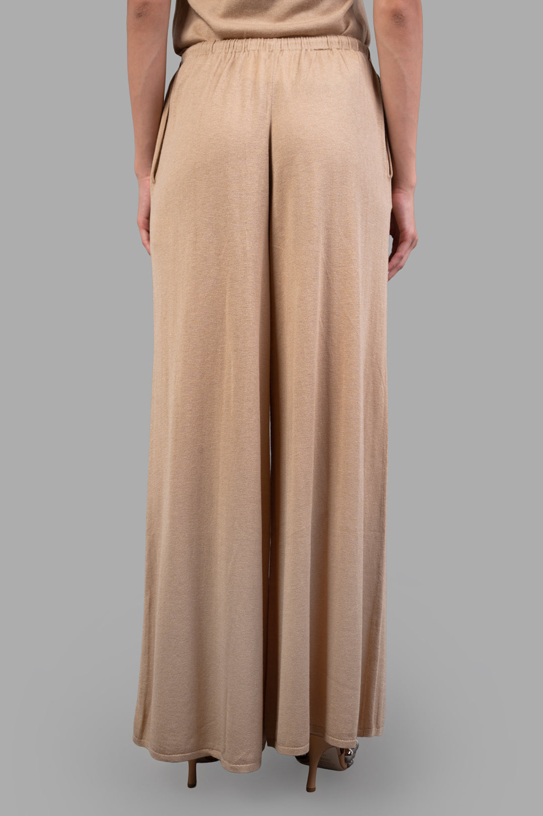By Malene Birger Drawstring Trousers, beige, featuring wide legs, loose silhouette, and adjustable tie waist viewed from the back.
