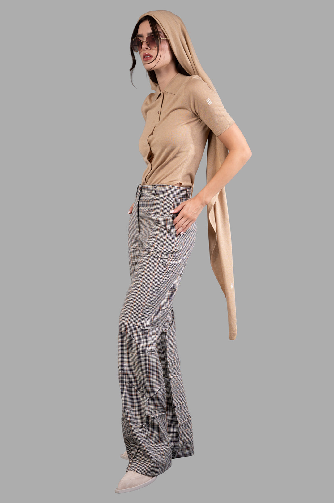 By Malene Birger Dotta Blouse in beige, front view on-model with collar and buttons, paired with checked trousers.