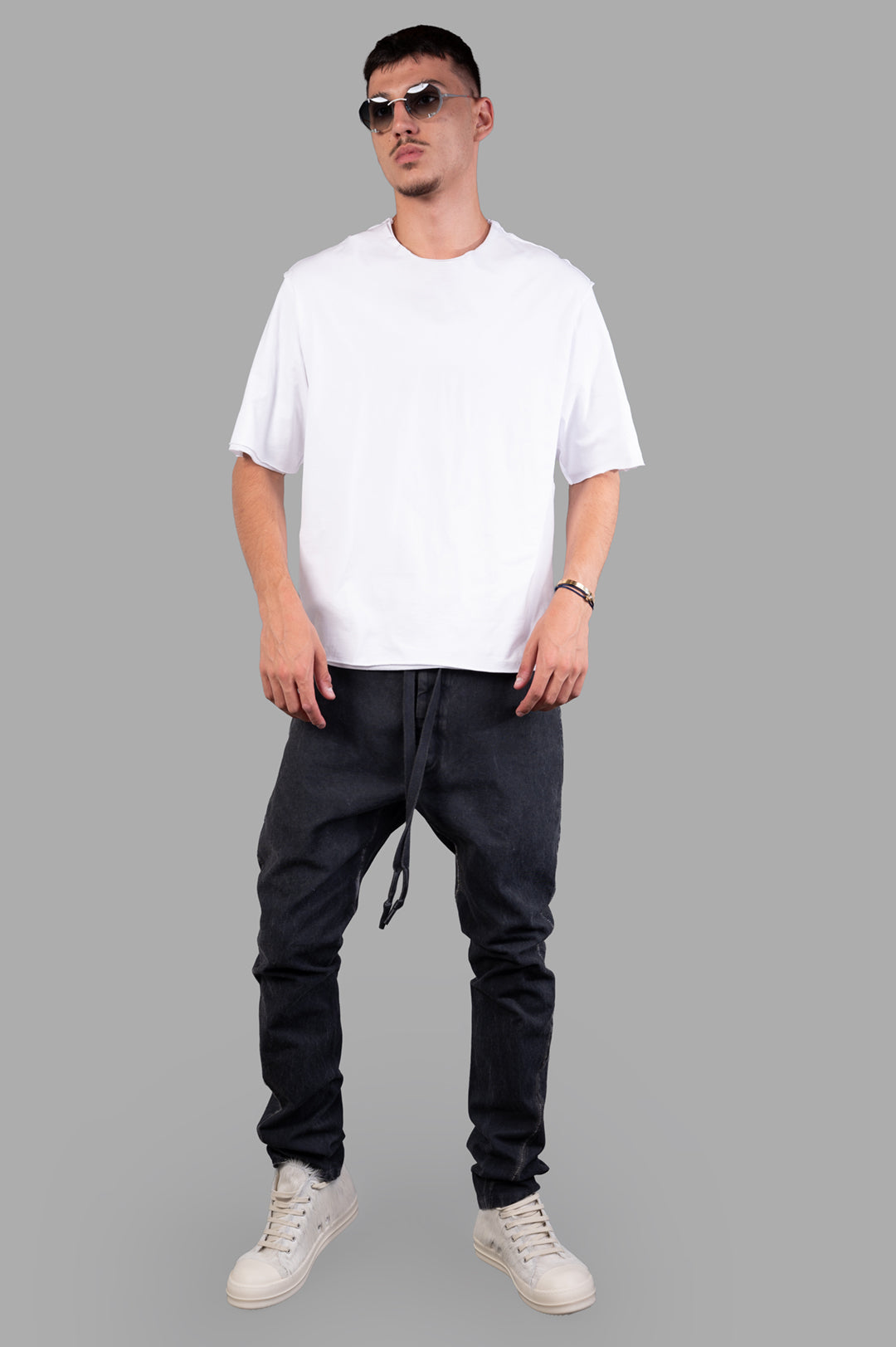Isaac Sellam Carrot-fit Trousers, front view on-model with white shirt and sneakers, image 1.