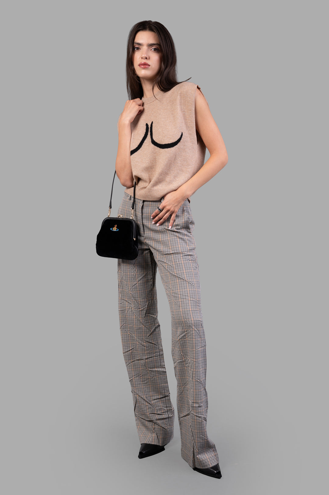 MSGM Creased Plaid Trousers on model, showcasing high-waisted fit and brown pattern, with tailored silhouette and black heels.