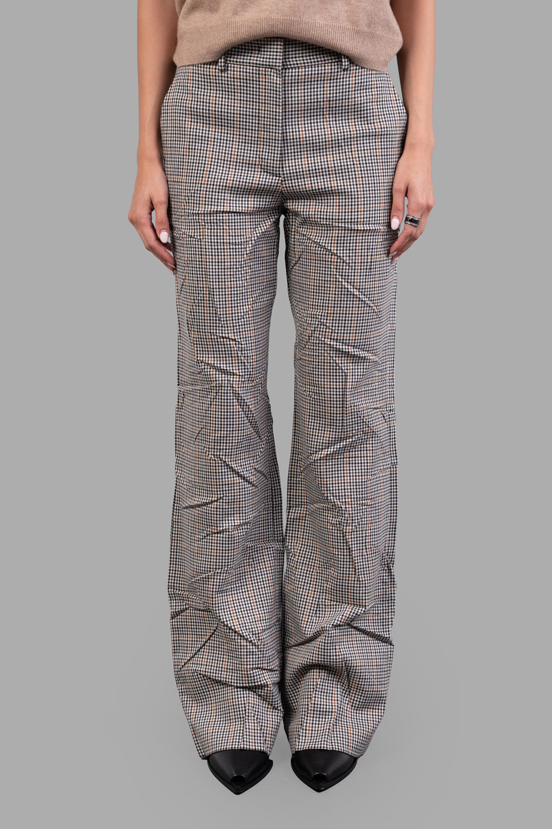 MSGM Creased Plaid Trousers displayed on-model in brown; high-waisted with a sophisticated crease effect and tailored fit.