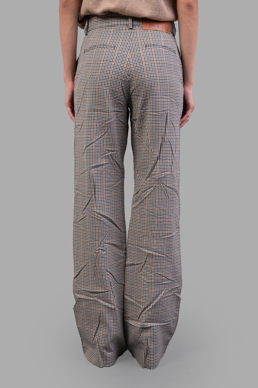 MSGM Creased Plaid Trousers, high-waisted with a crease effect, showcasing a tailored fit and sophisticated brown plaid pattern.