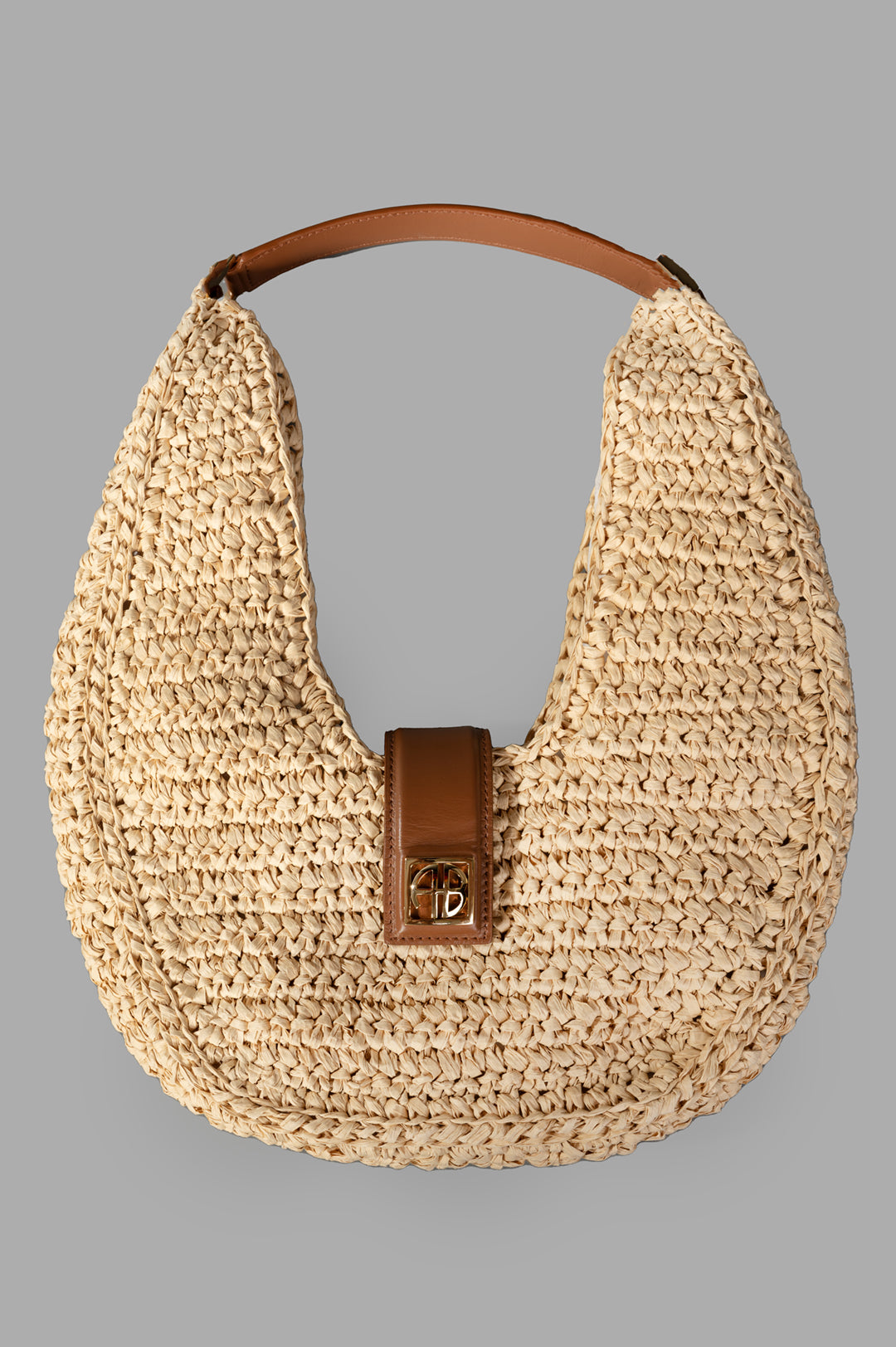 Anine Bing Raffia Monogram Shoulder Bag in Tan, front view showing raffia texture and leather trim with gold-tone hardware.