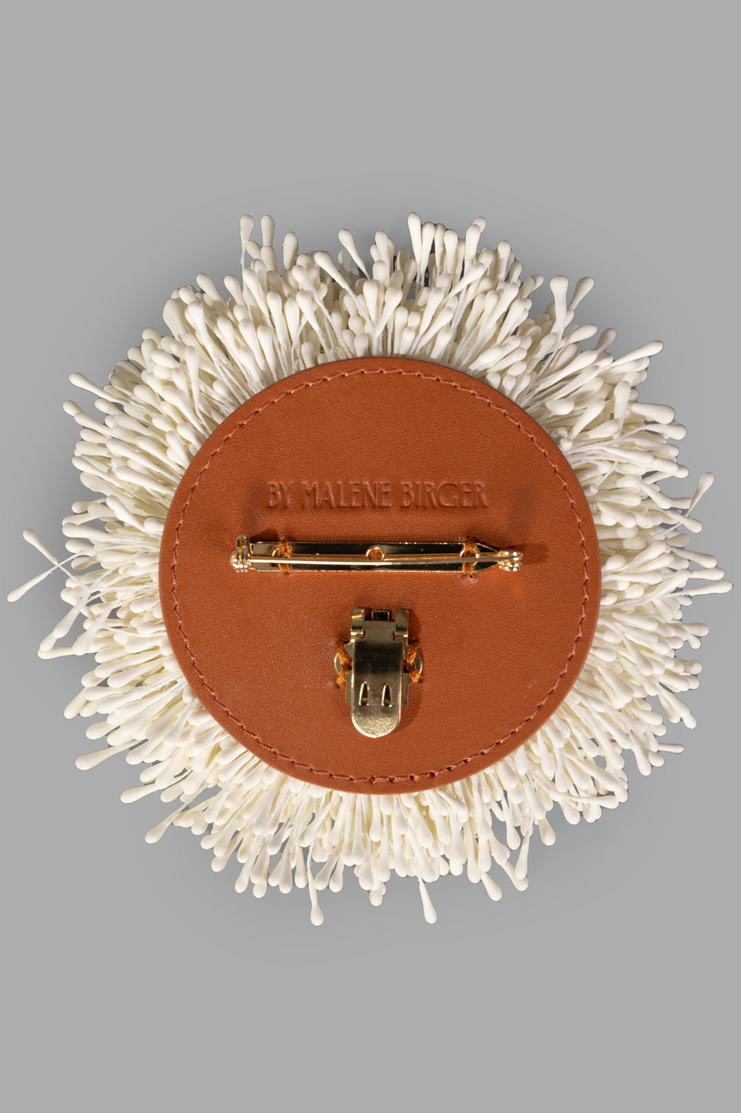 By Malene Birger Henna Brooch in White, featuring a floral design with a gold tube hinge and leather backing.