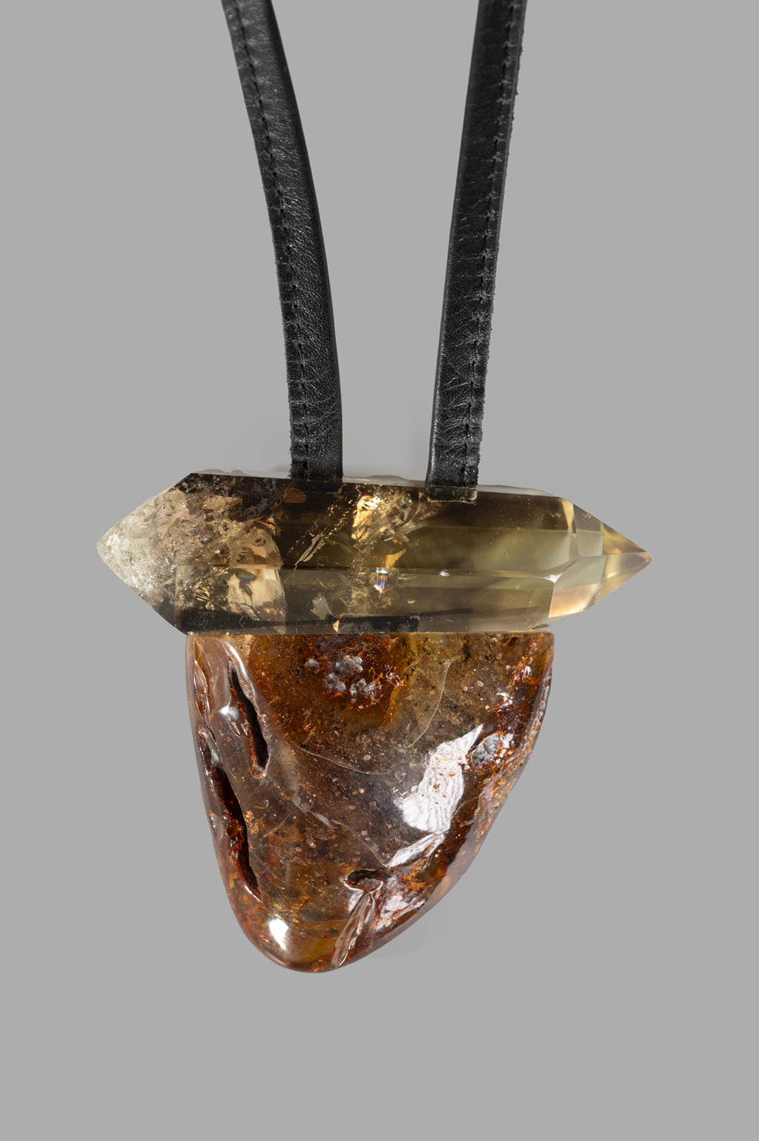 Monies Pendant Necklace with a striking amber and citrine pendant suspended from a sturdy leather cord, highlighting.