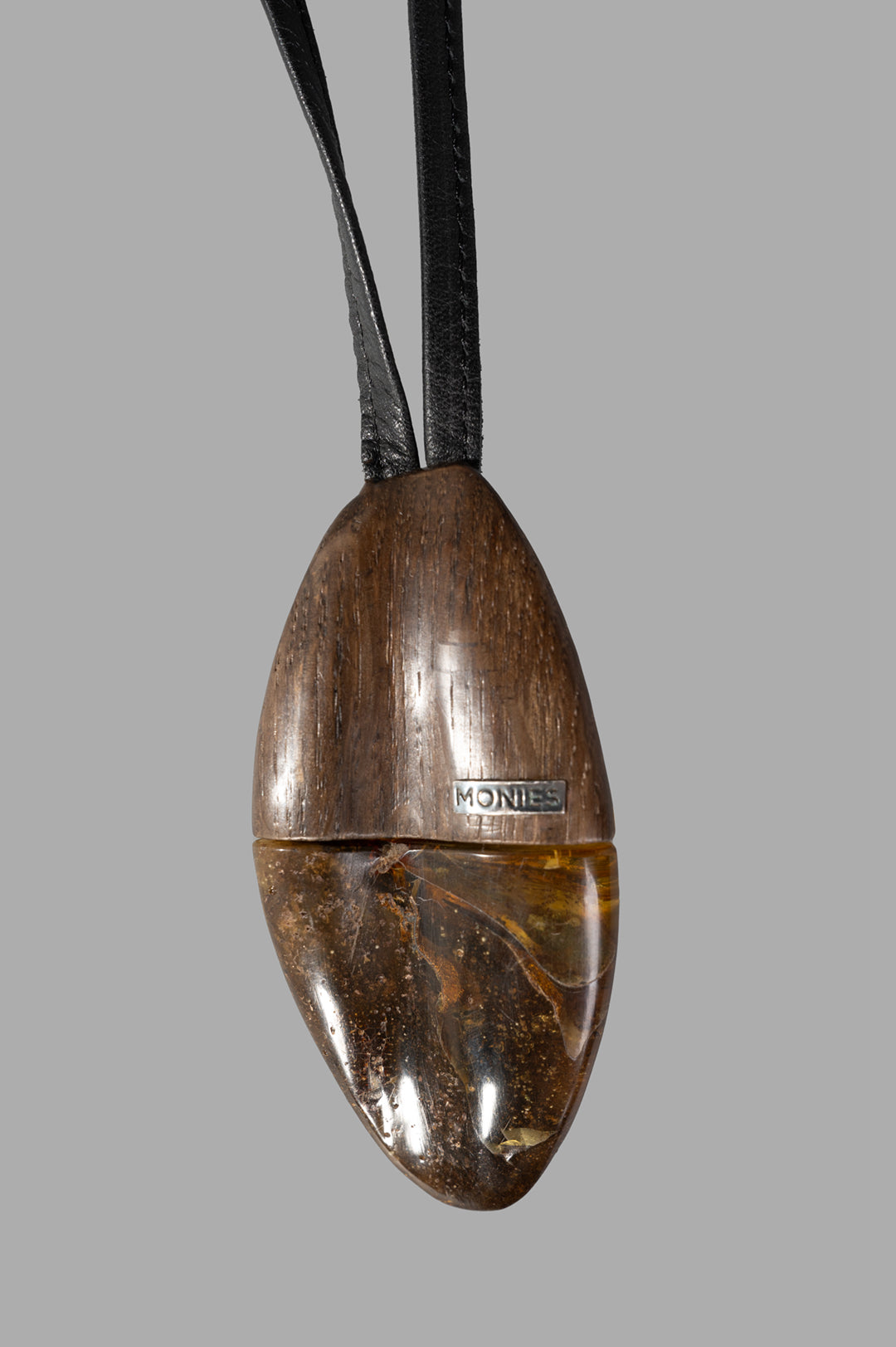 Monies Pendant Necklace featuring a large amber stone pendant on a durable leather strap for bold, sophisticated style.