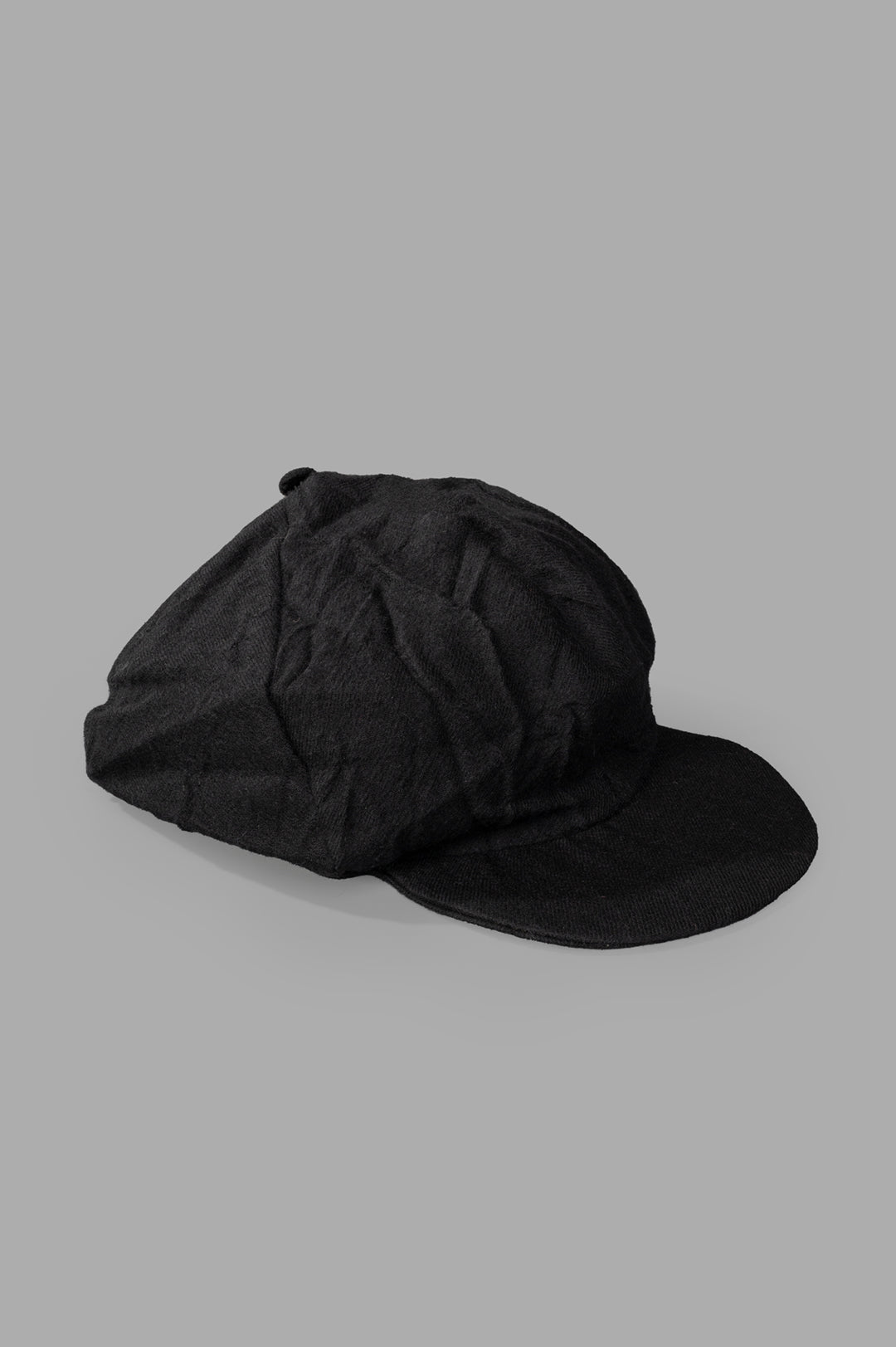 Marc Point black newsboy cap side view, featuring premium wool fabric and a reinforced brim for durability.
