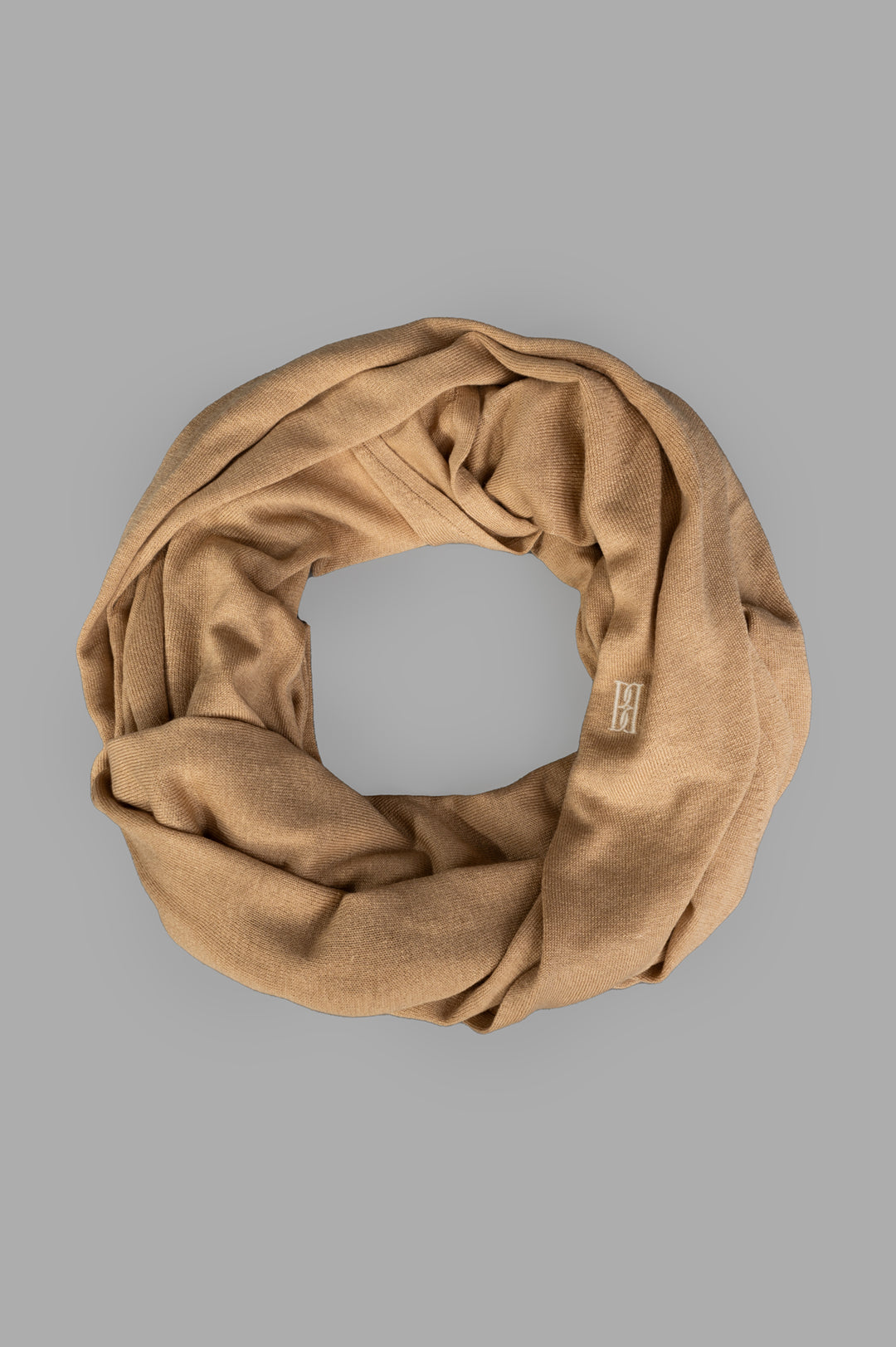 By Malene Birger Dorothea Scarf in beige, top view, showing wool mix texture and embroidered monogram detail.