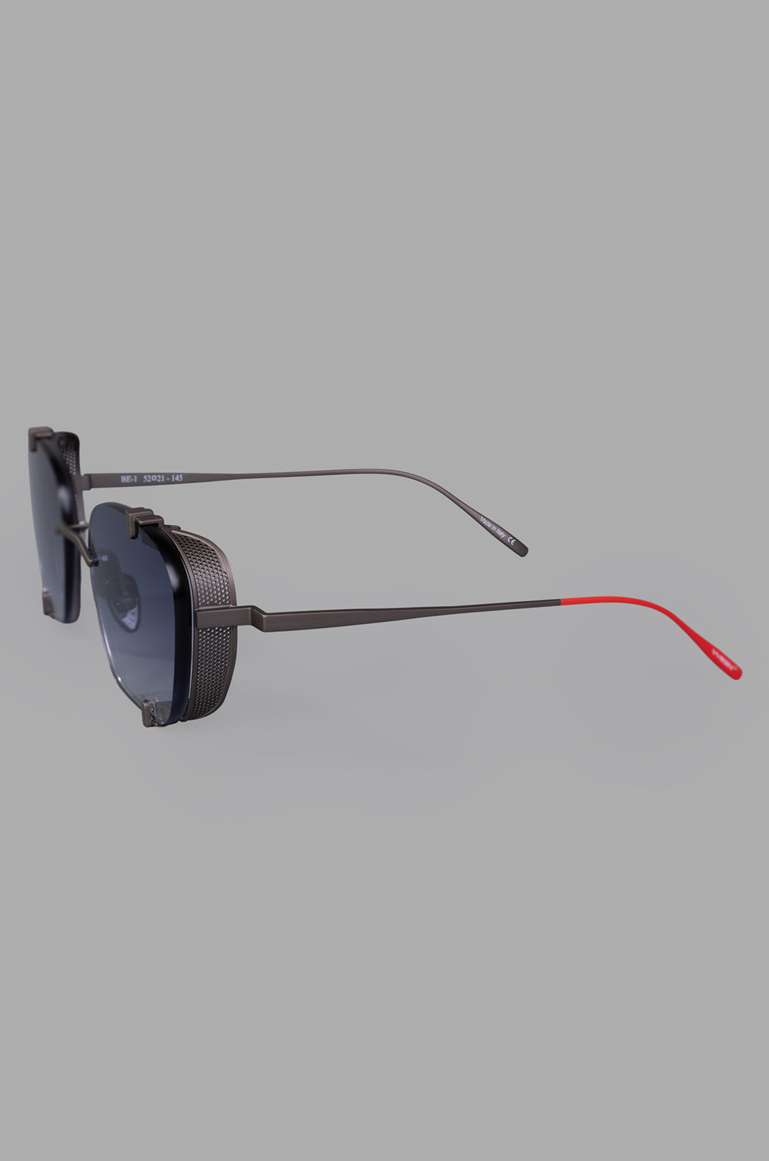 Vysen Eyewear. The Bei - BE2 rimless titanium sunglasses showcasing a sleek side view with stylish red accents.