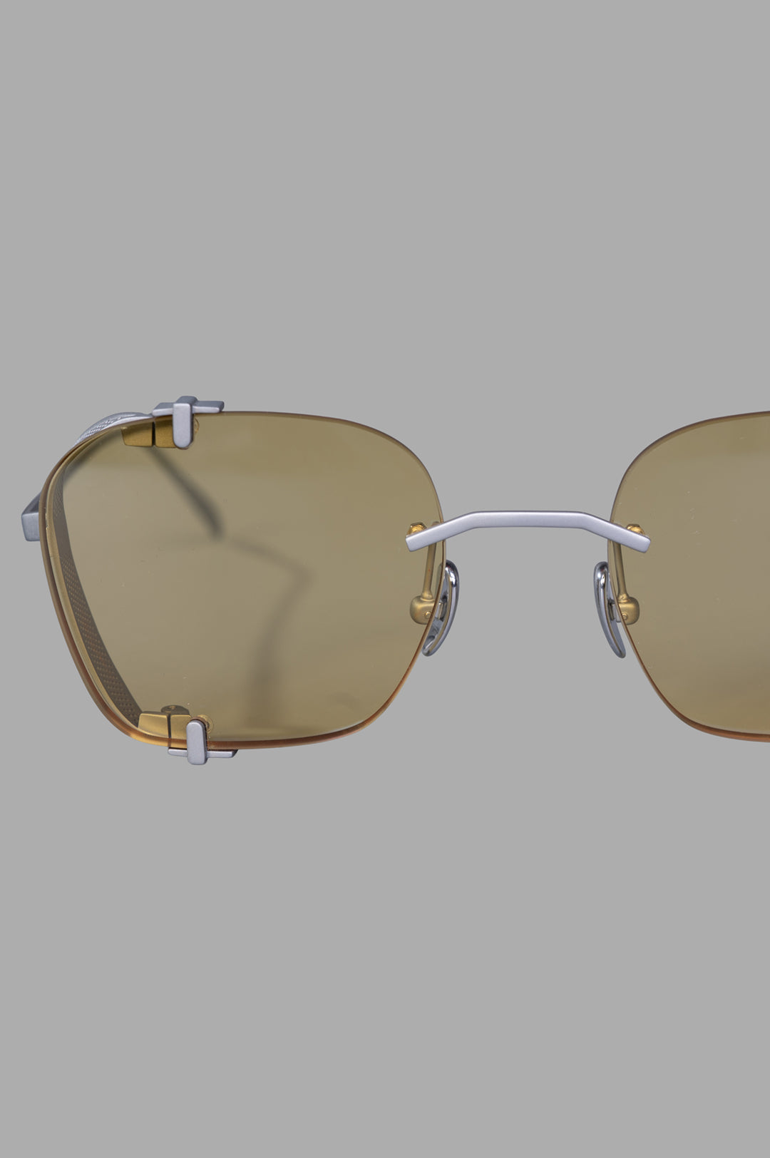 Vysen Eyewear The Bei - BE3 showcases rimless titanium sunglasses with clear yellow lenses, highlighting a bold clubmaster.