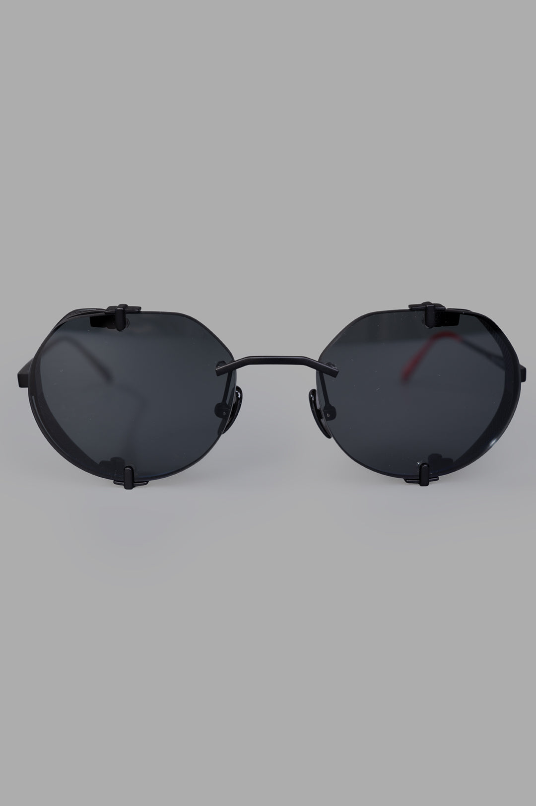 Vysen Eyewear The Uttar - UT1 black matte rimless titanium round sunglasses, front view, highlighting minimalist design.