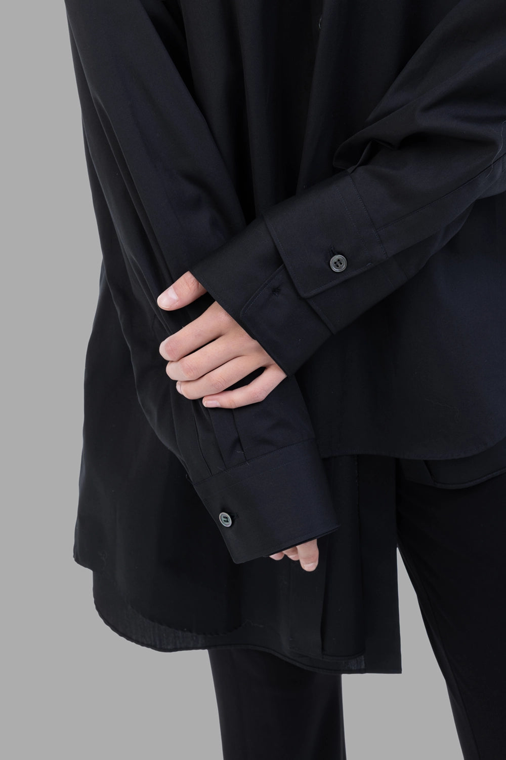 Comme des Garçons women black shirt, cuff detail, pleated sleeve with single-button cuff.