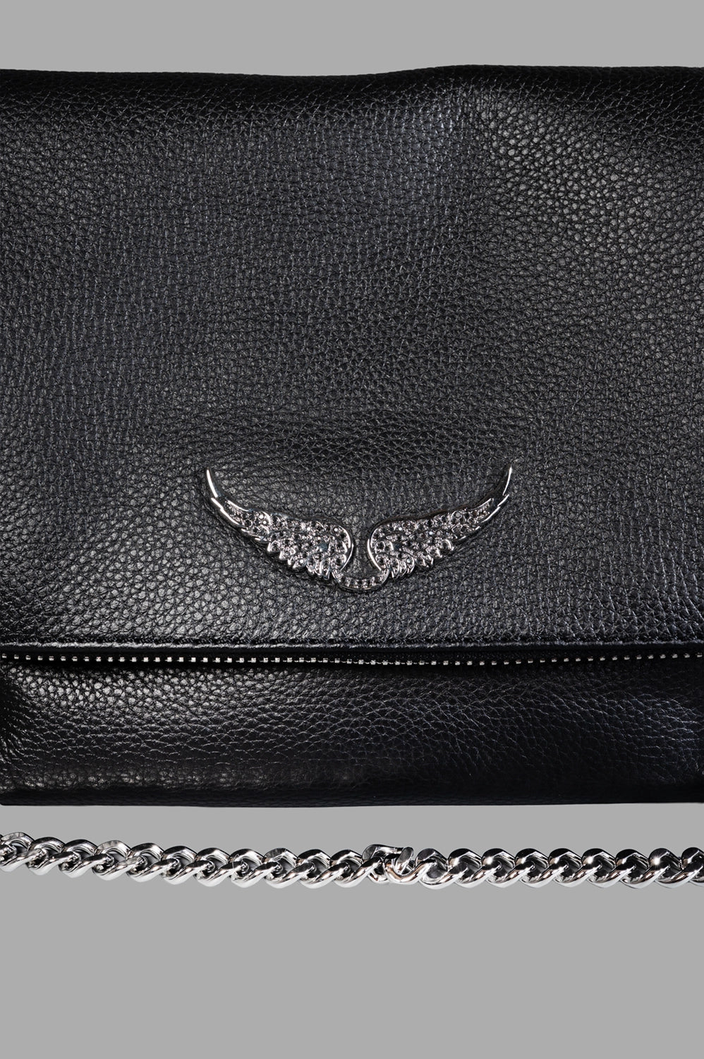 Zadig & Voltaire shoulder bag in black, logo close-up, crystal-studded wings on pebbled leather above zipper