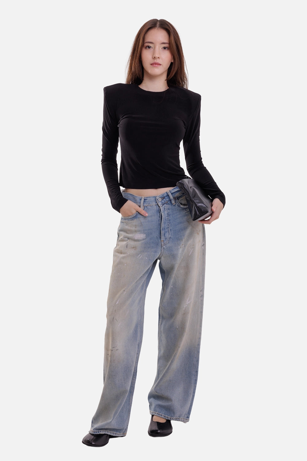 Norma Kamali women's black shoulder-pad top, on-model full-length view with fitted body and extended sleeves