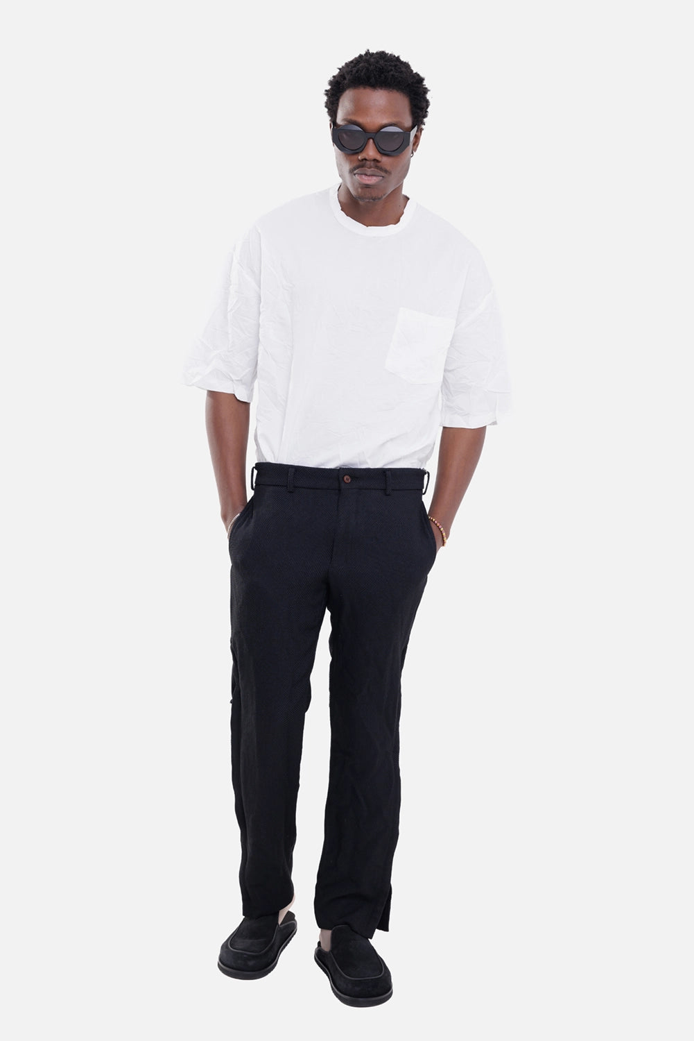 Comme des Garçons men's trousers in black, on-model full-length, textured fabric and straight-leg cut
