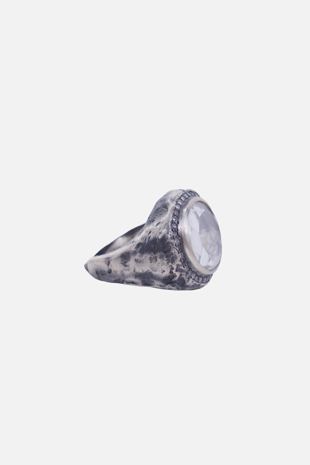 Kundo unisex signet ring in silver, three-quarter view with a hammered tapered band and raised setting