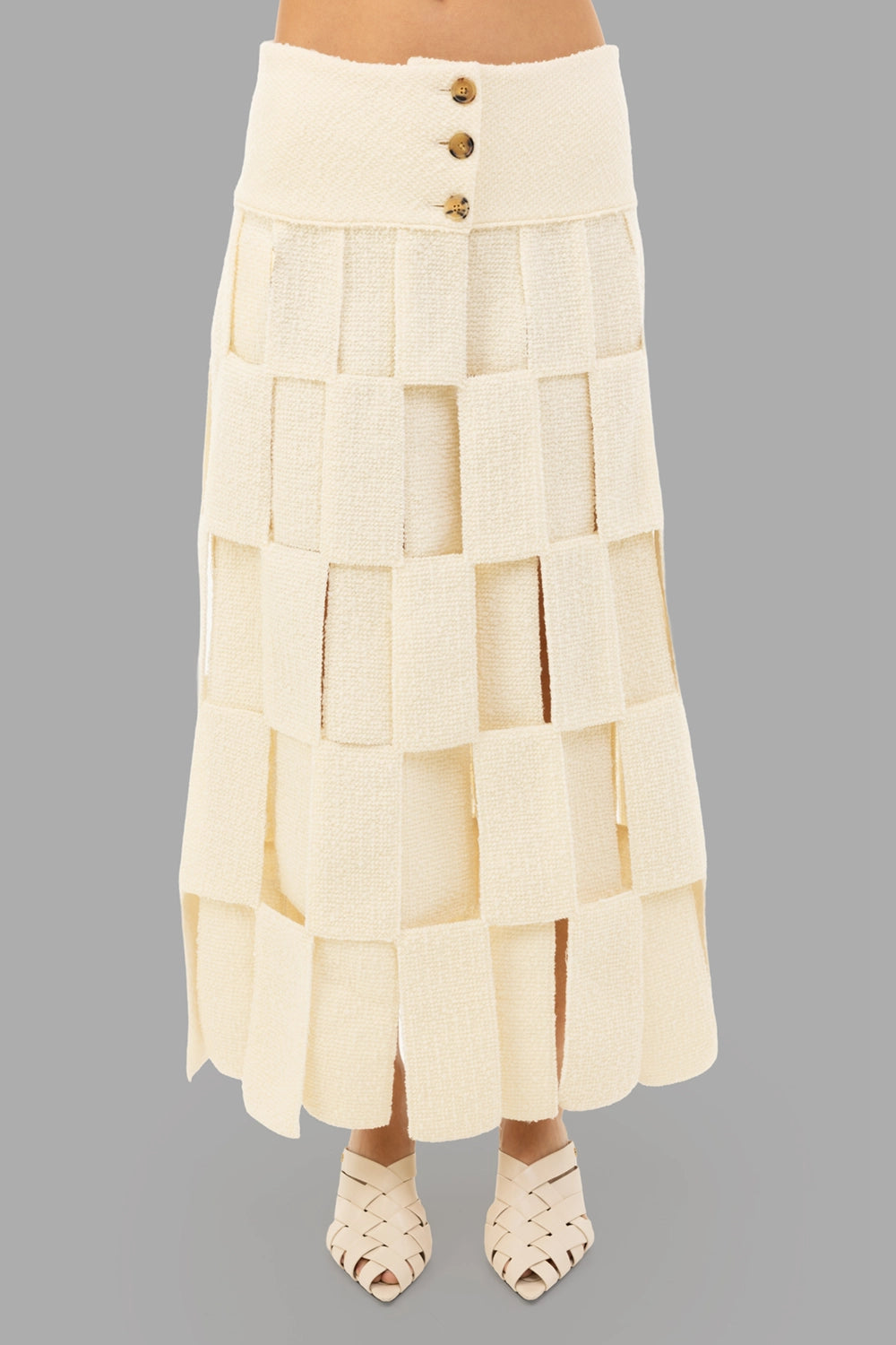 A.W.A.K.E. MODE women maxi skirt in ecru, front view, wide waistband with horn buttons and rectangular cut-outs.