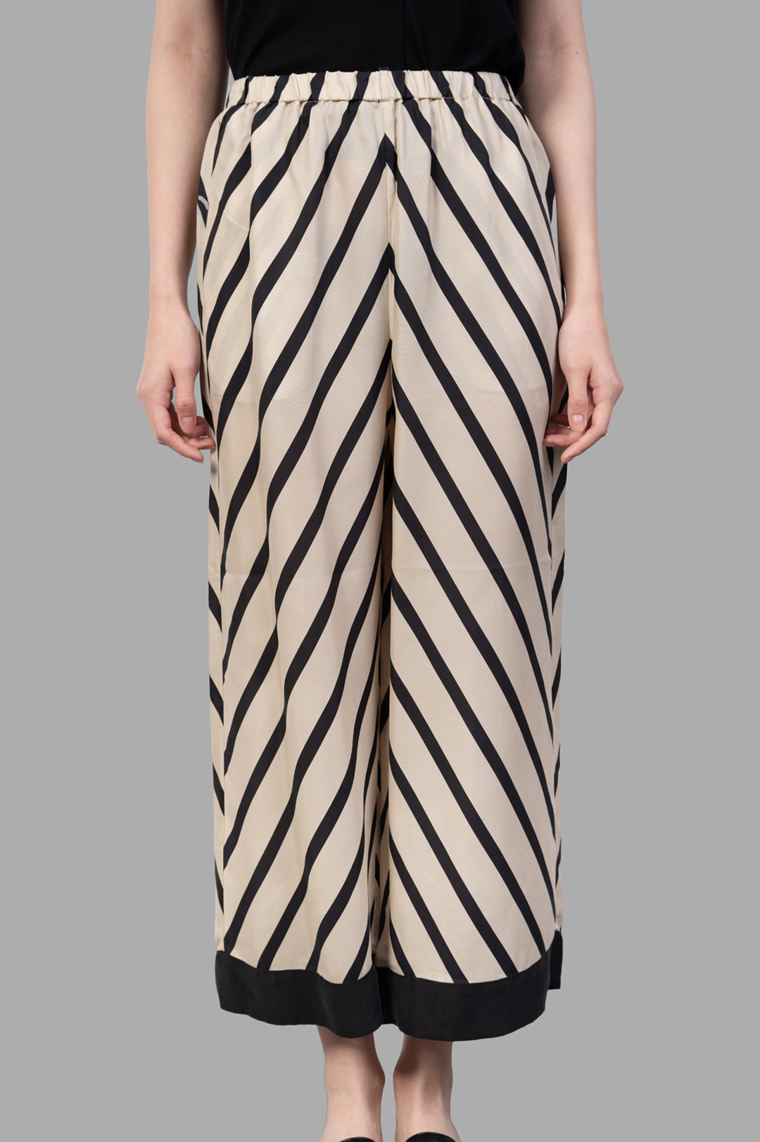 By Malene Birger Mirabello Wide-leg Trousers featuring a high elastic waistband and side pockets, shown in ecru with stripes.