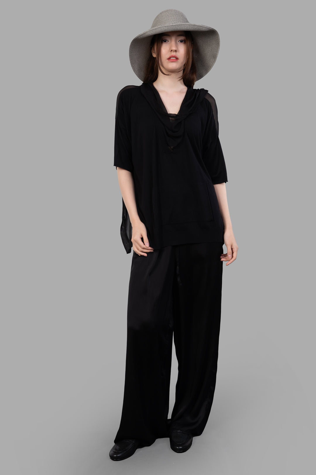 Masnada Layered T-shirt in black silk, front view with shawl collar and hood, worn by model, showcasing abbreviated sleeves.