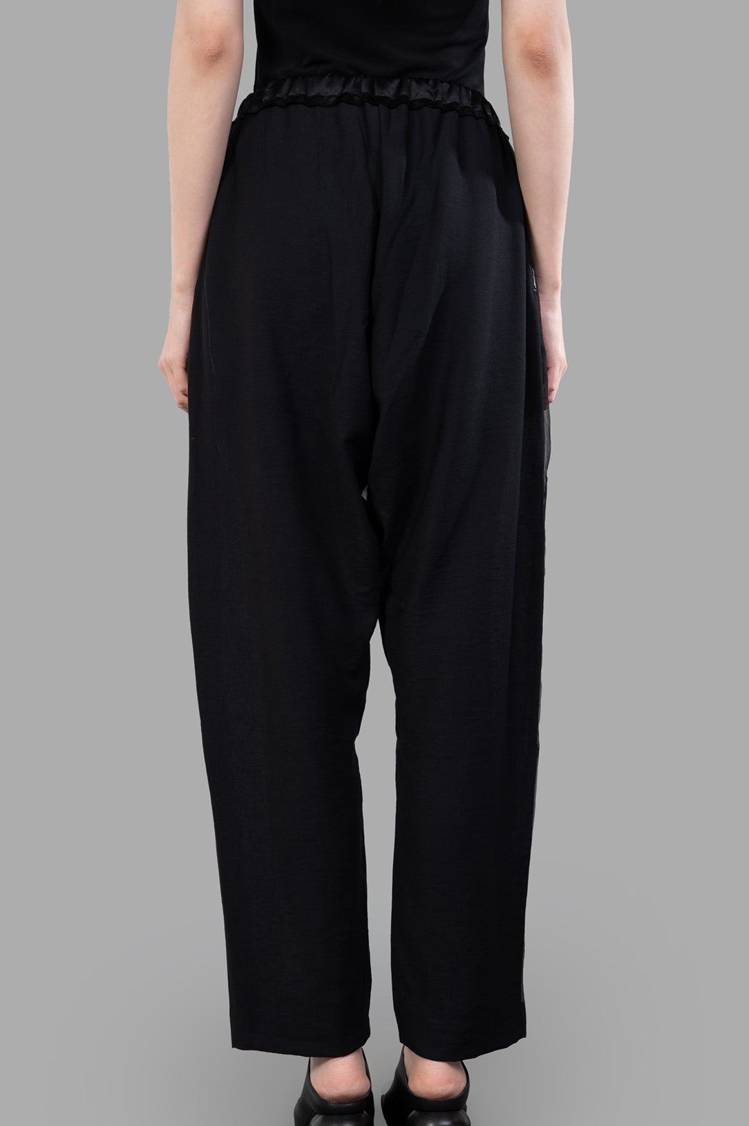 Giovanni Cavagna Semi-sheer Pants showcase a relaxed fit, with a stylish elastic waistband and luxurious black silk fabric.