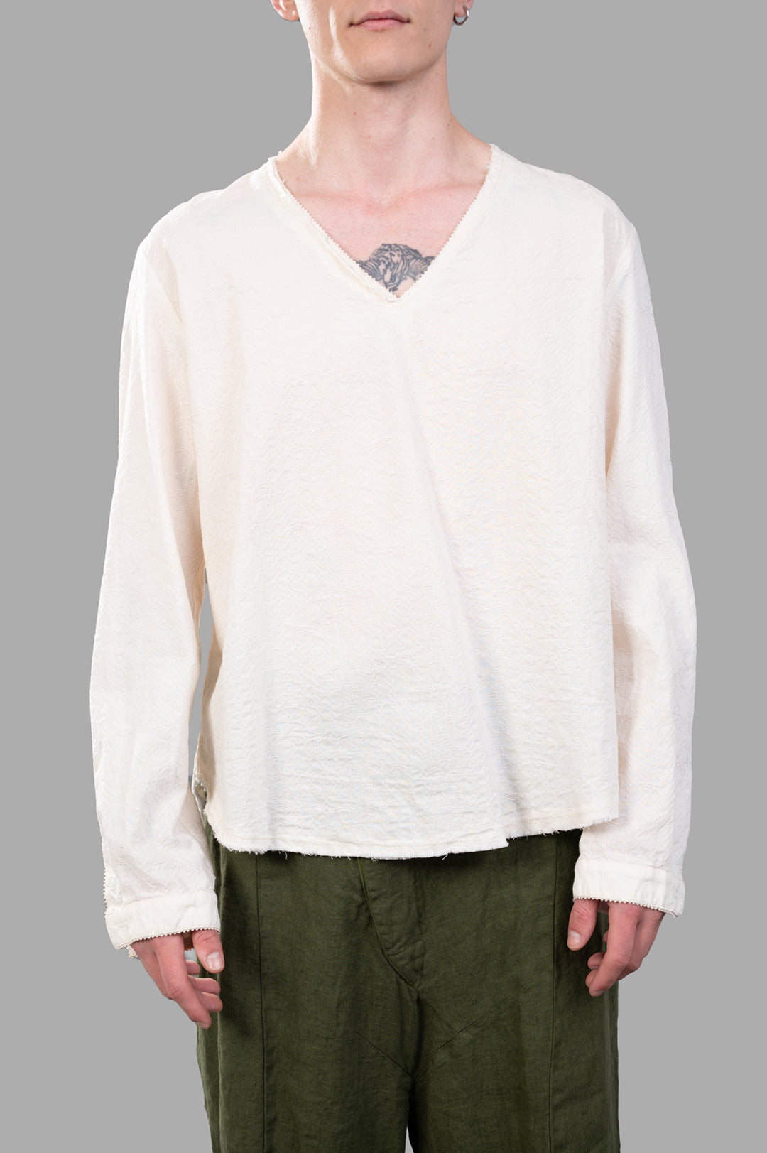 Marc Point V-neck Blouse in ecru, showcasing a relaxed fit and asymmetric hem, worn on a model for style context.