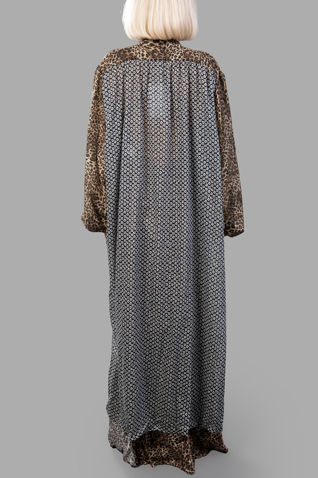 Anjuna Leopard Cape showcasing a back view with a blend of leopard print and delicate graphic patterns. Luxurious fabric.
