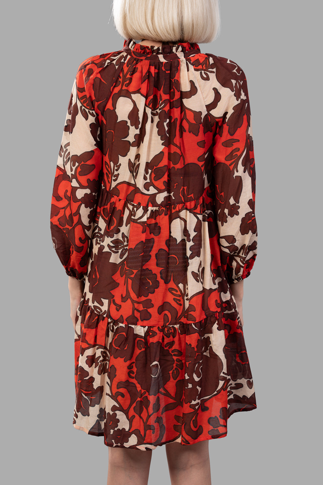 Anjuna Naike Mini Dress, showing back detail with rich red floral pattern and elasticated cuffs for a flowy design.
