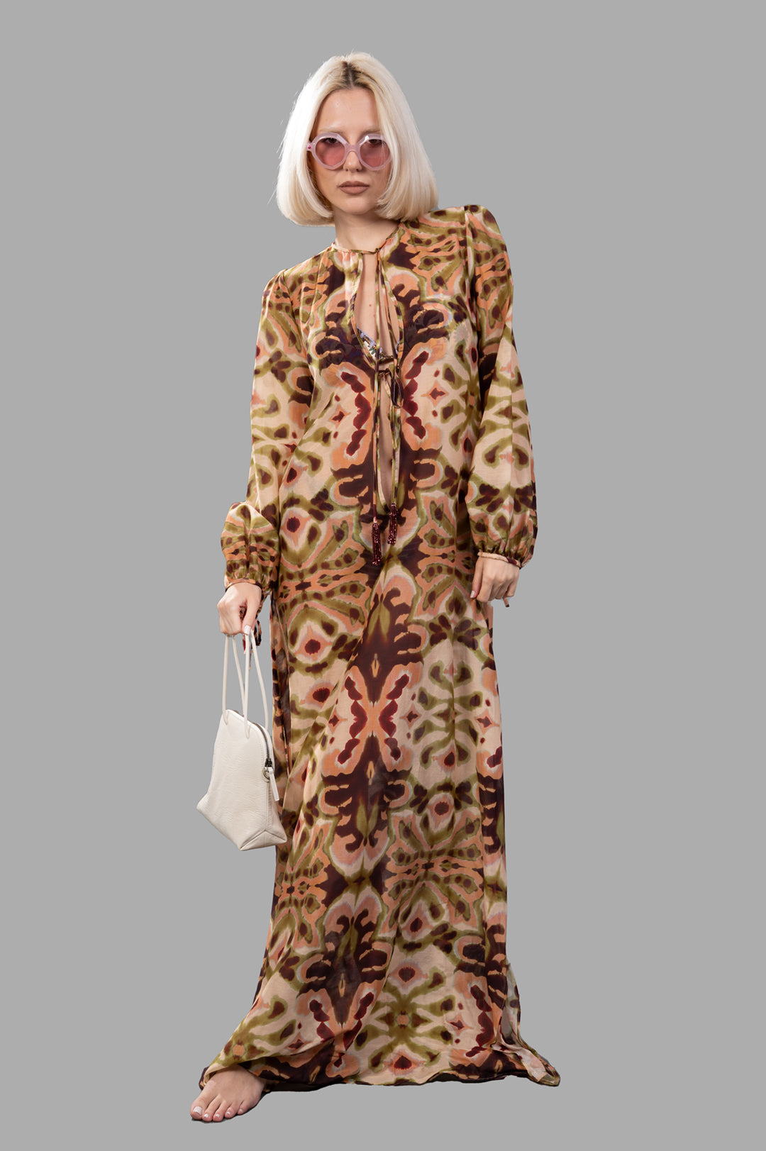Anjuna Abstract-print Maxi Dress on model, front view, with pink sunglasses and a white purse.