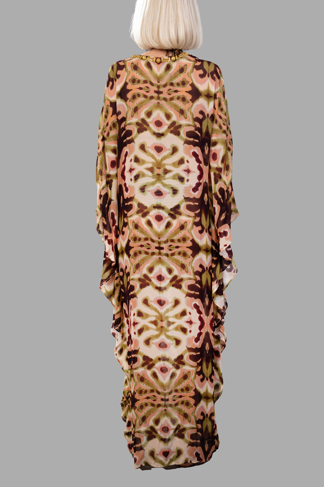 Anjuna Abstract-print Kaftan Dress displayed on a model, showcasing a vibrant, flowing pattern from the back.