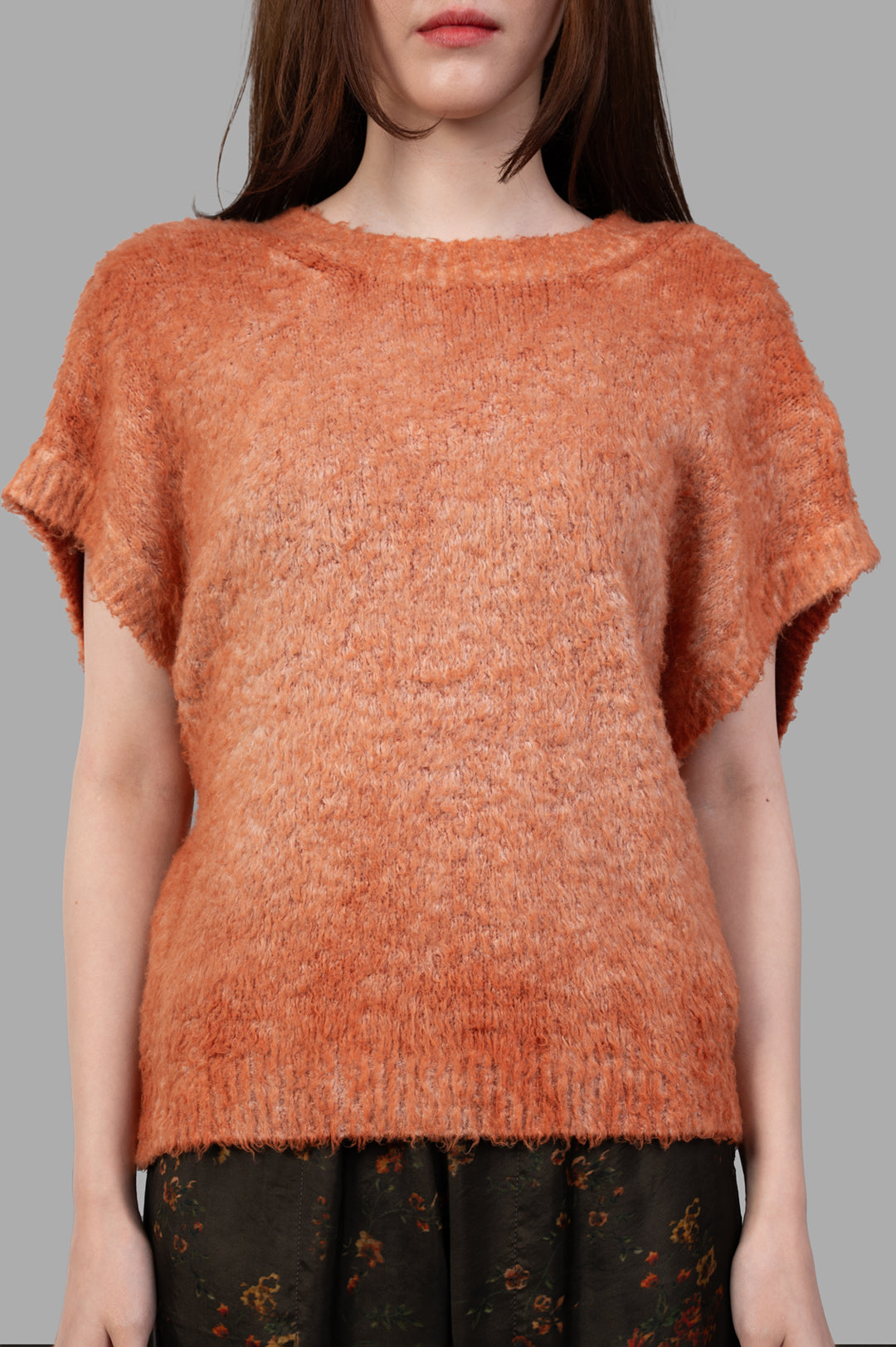 Avant Toi Cap-sleeve Sweater in soft orange, featuring a relaxed fit and textured knit, modeled from the front.