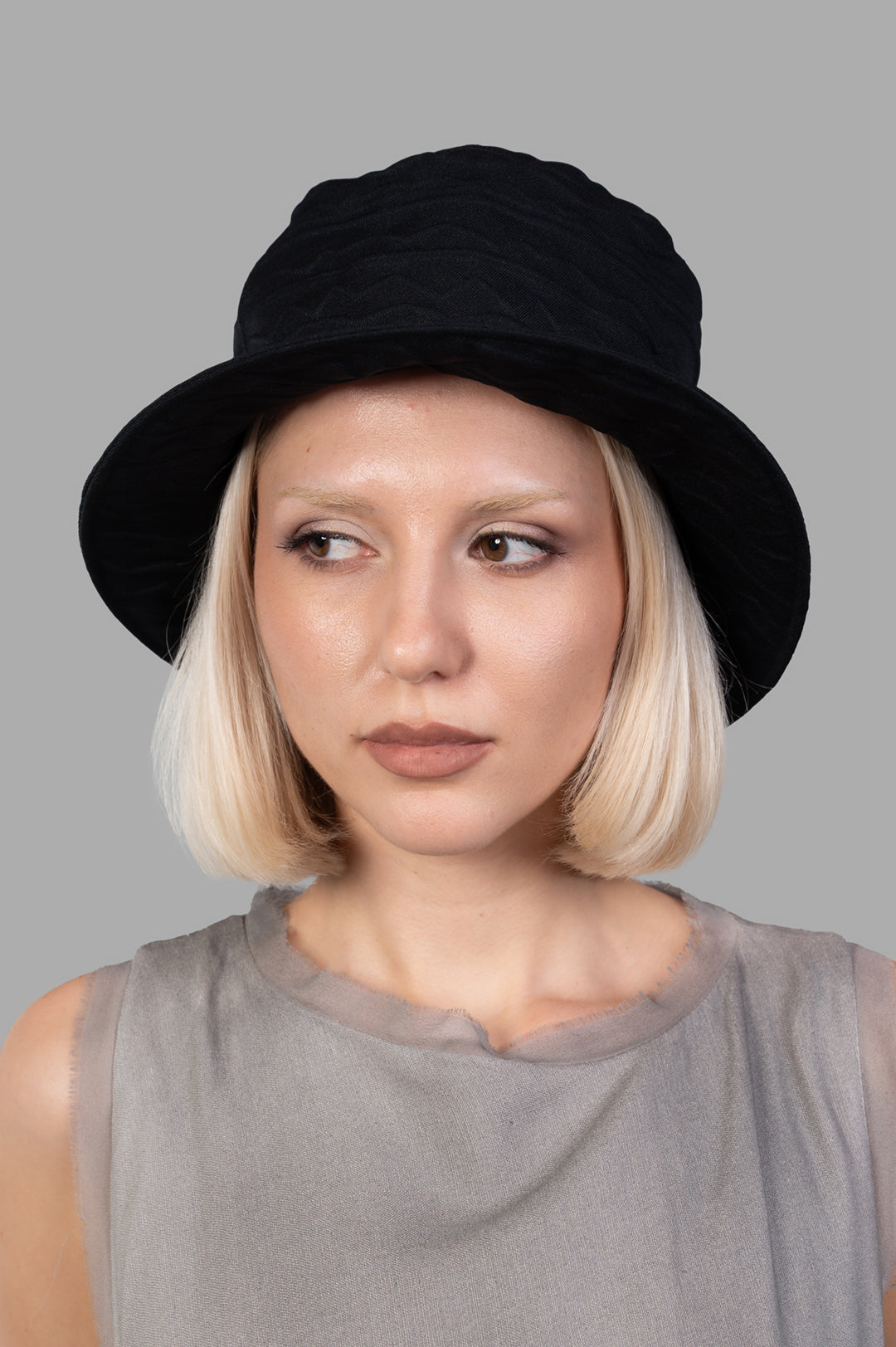 Kijima Takayuki Textured Bucket Hat on model, showcasing intricate black fabric and stylish design. Handcrafted in Japan.