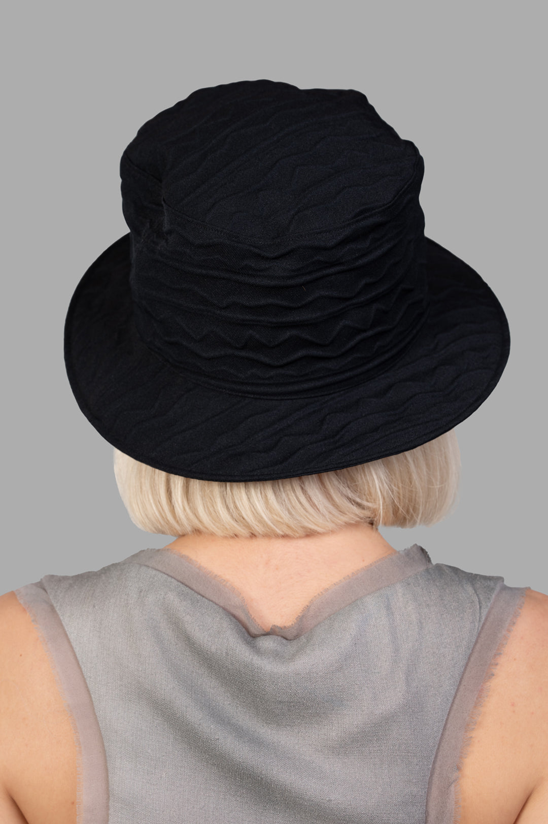 Kijima Takayuki Textured Bucket Hat in black, showcasing a unique wavy texture from a back view on a model.