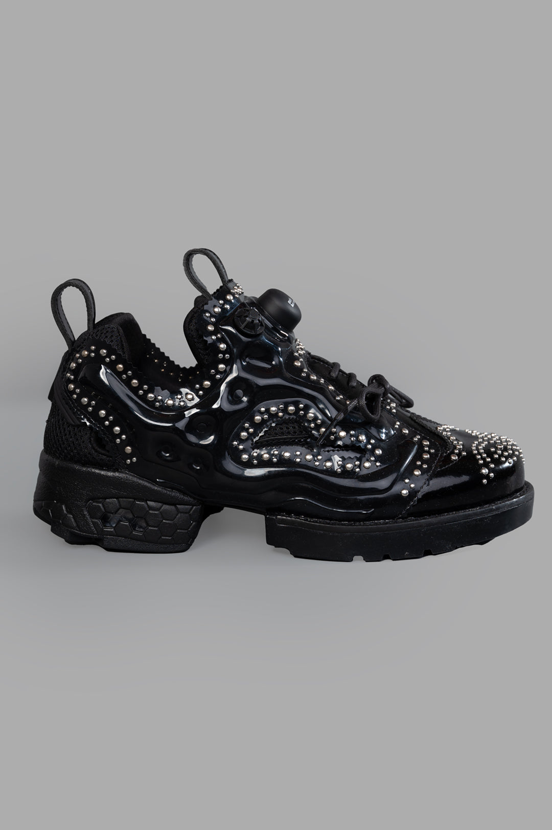 Noir Kei Ninomiya x Reebok Instapump Fury Sneakers side view, black with stud embellishments and durable rubber sole.