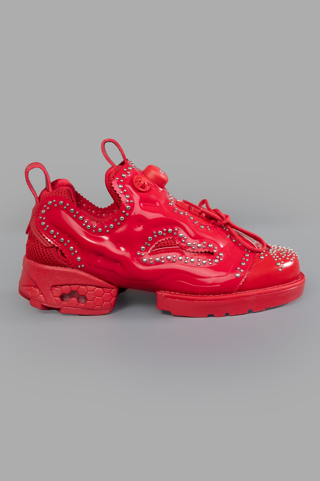 Noir Kei Ninomiya x Reebok Instapump Fury Sneakers in Red, side view with stud details and lace-up design, polyurethane.