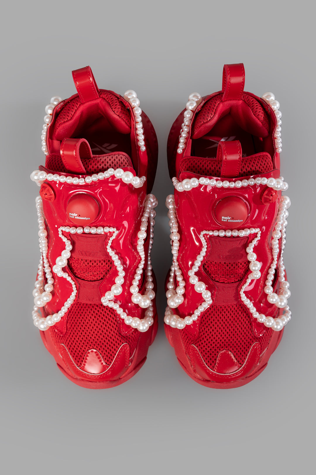 Noir Kei Ninomiya x Reebok Pearl-embellished Sneakers in Red, featuring pearl details and dual pull-tabs, top view.