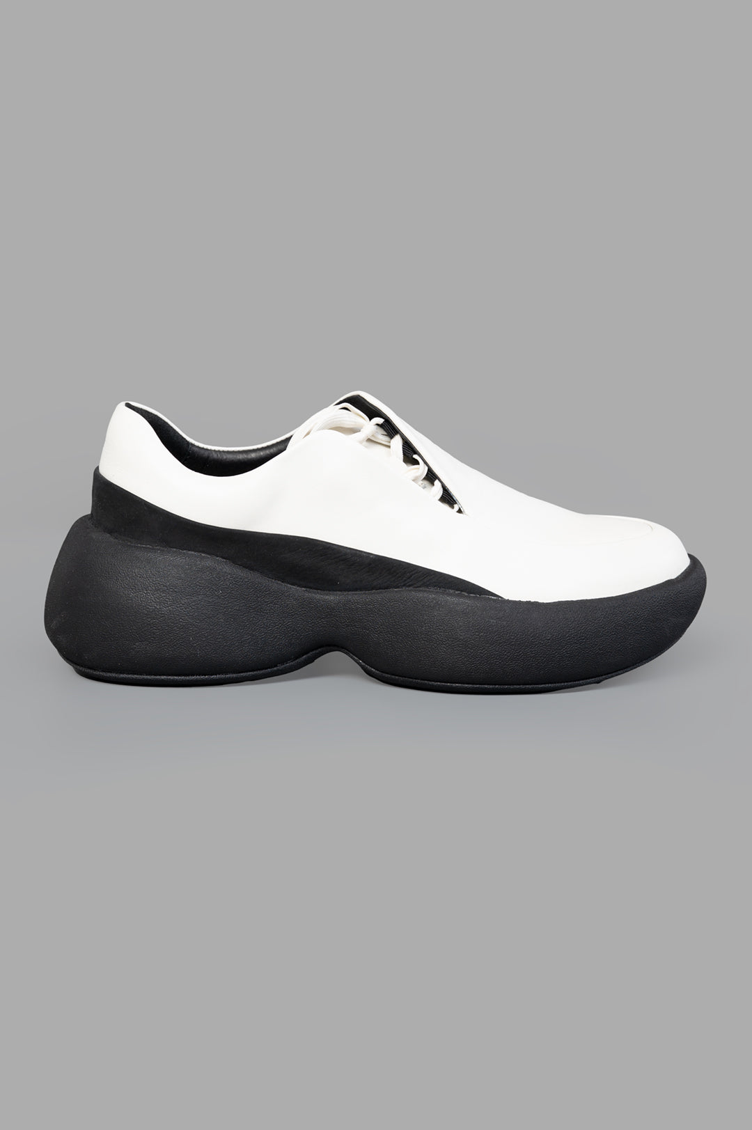Vein Leather Platform Sneakers, side view showcasing black and white design with elevated rubber platform and rounded.